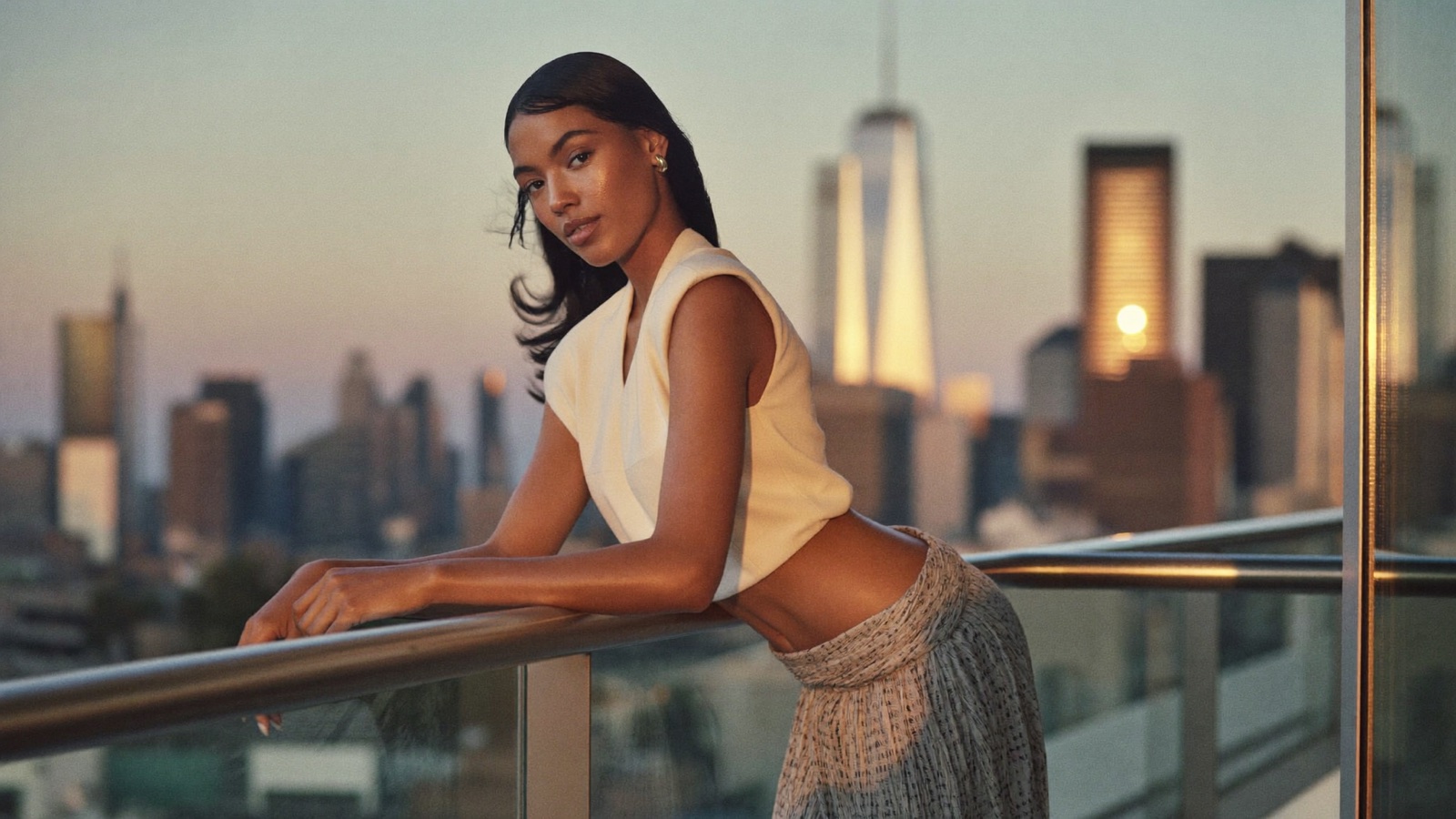 A creator on a city balcony at golden hour
