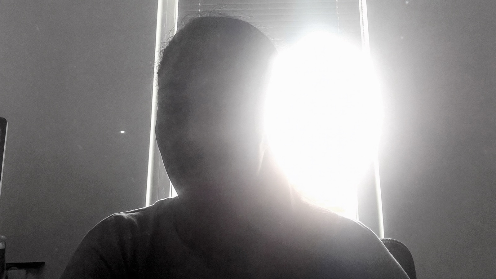 What the camera sees when a bright window is behind the model: her face is a black silhouette inside blinding glare