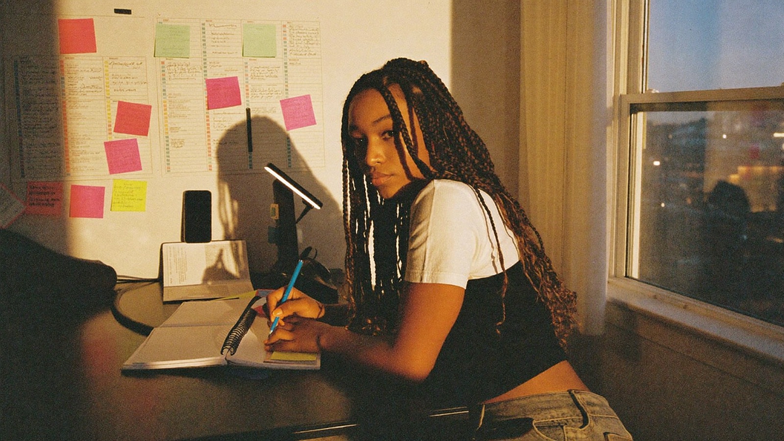 A creator planning her weekly content calendar at a desk